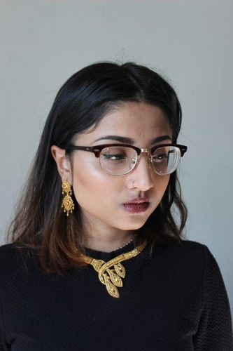 gold jewelry black sweater