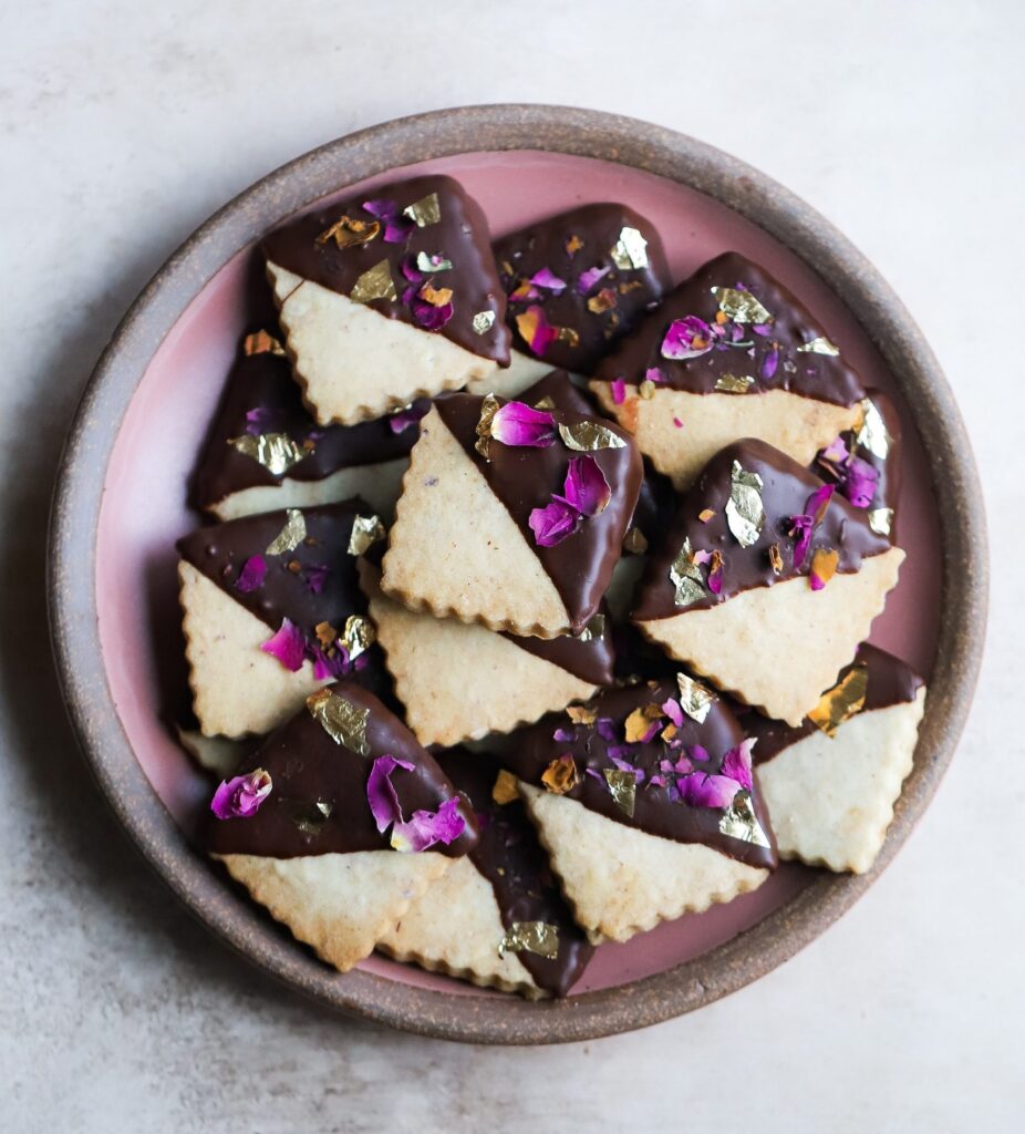 LNUT AND CARDAMOM SHORTBREAD dipped in ROSE INFUSED CHOCOLATE: